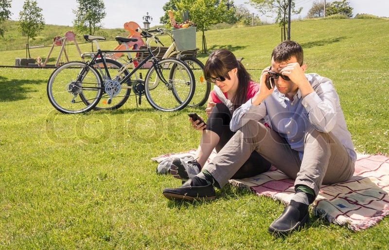 10503302-couple-in-love-using-a-smartphones-on-the-park